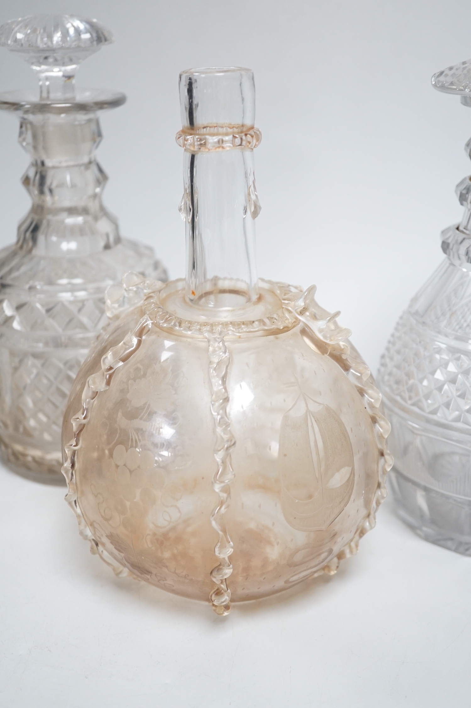 Two Dutch wheel engraved glass flasks and two Regency cut glass decanters, flasks 23cm high (4)